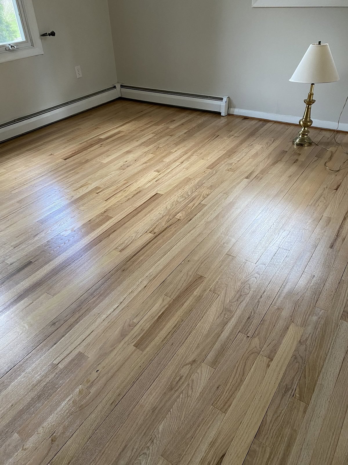 Vernon home with refinished oak hardwood flooring in a bright living room with natural light