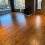 Oak hardwood floor refinished with Early American stain in a Bolton CT family room with a wood stove.