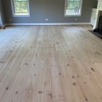Bright natural pine hardwood flooring refinished with Bona NordicSeal and Mega in a Burlington Connecticut living room.