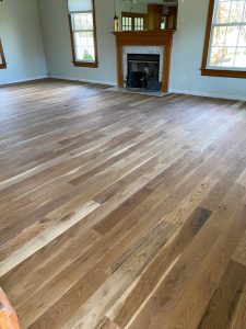 Wide-width character white oak flooring installed in an Enfield CT 06082 home with a light stain and matte oil-based polyurethane finish
