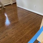 New unfinished hardwood flooring meeting existing hardwood during installation in Simsbury Connecticut