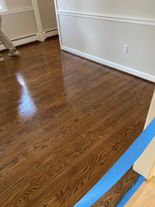 New unfinished hardwood flooring meeting existing hardwood during installation in Simsbury Connecticut