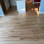 Refinished prefinished hardwood flooring transitioning into kitchen floor in Wethersfield Connecticut