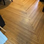 Existing early-1900s hardwood kitchen floor with an elaborate log-cabin-style border pattern in Willimantic, CT.